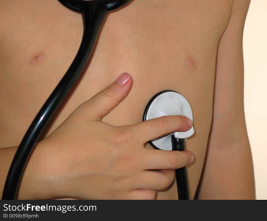 Small boy listening for his heartbeat with a stethoscope. Small boy listening for his heartbeat with a stethoscope