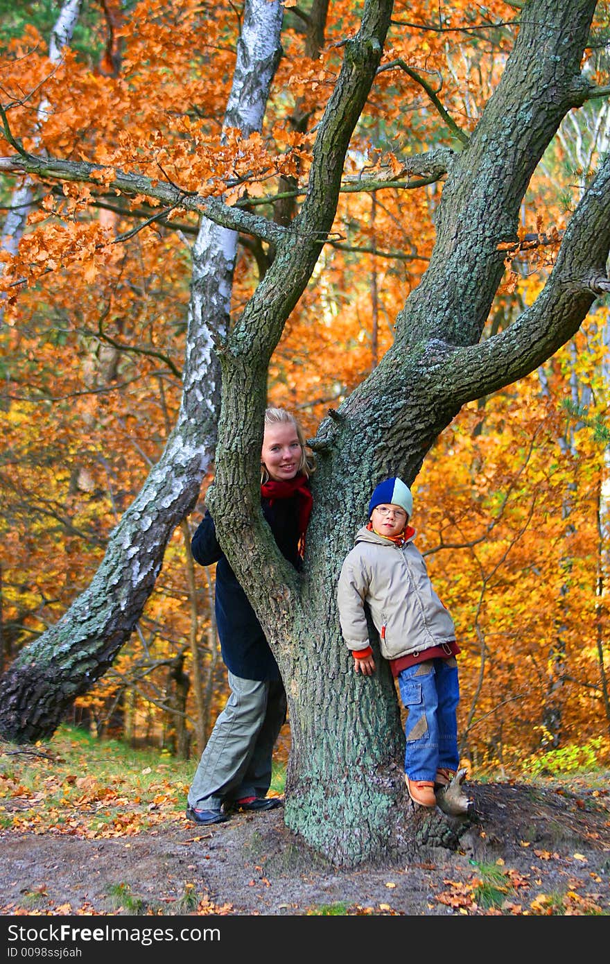 Mother and san in an autumn wood