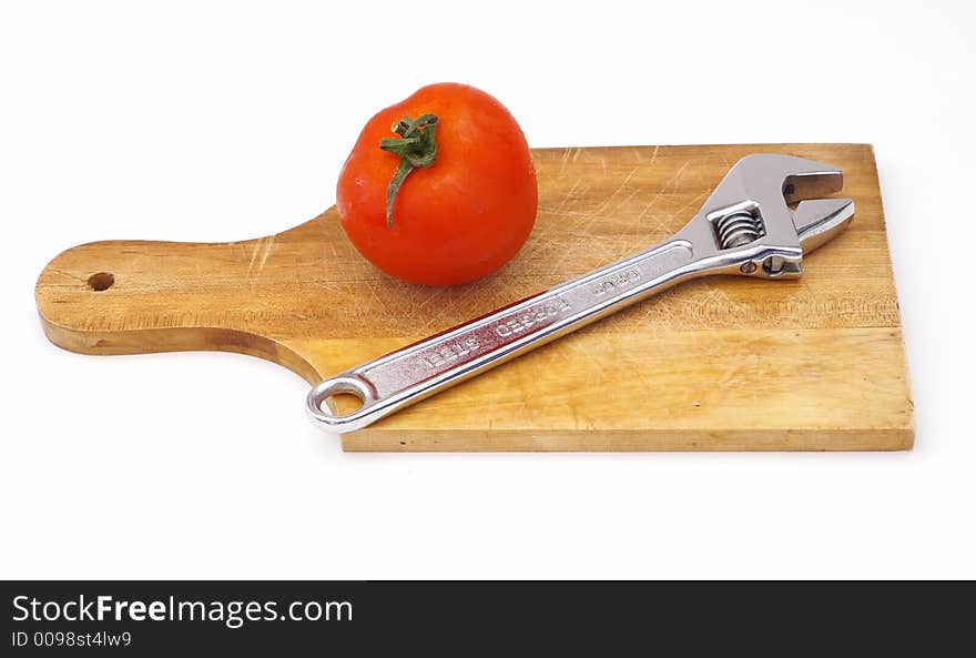 Screw a tomato on a wooden plate