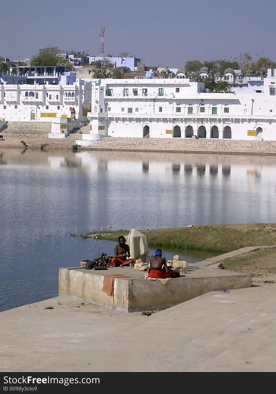 Indian holy men meditating near a lake