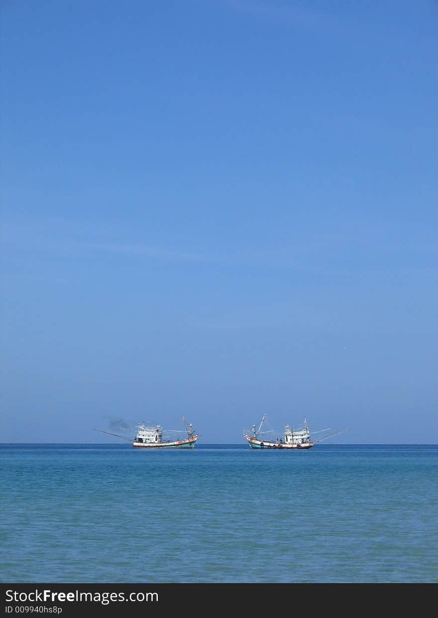 Two ships passing each other in the ocean off Thailand Coast. Two ships passing each other in the ocean off Thailand Coast.