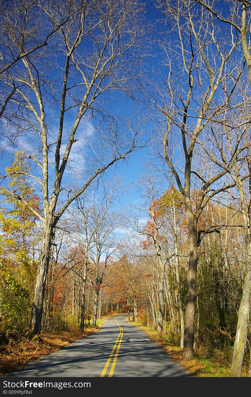 A macadem road into fall scenery in rural Pennsylvania. A macadem road into fall scenery in rural Pennsylvania