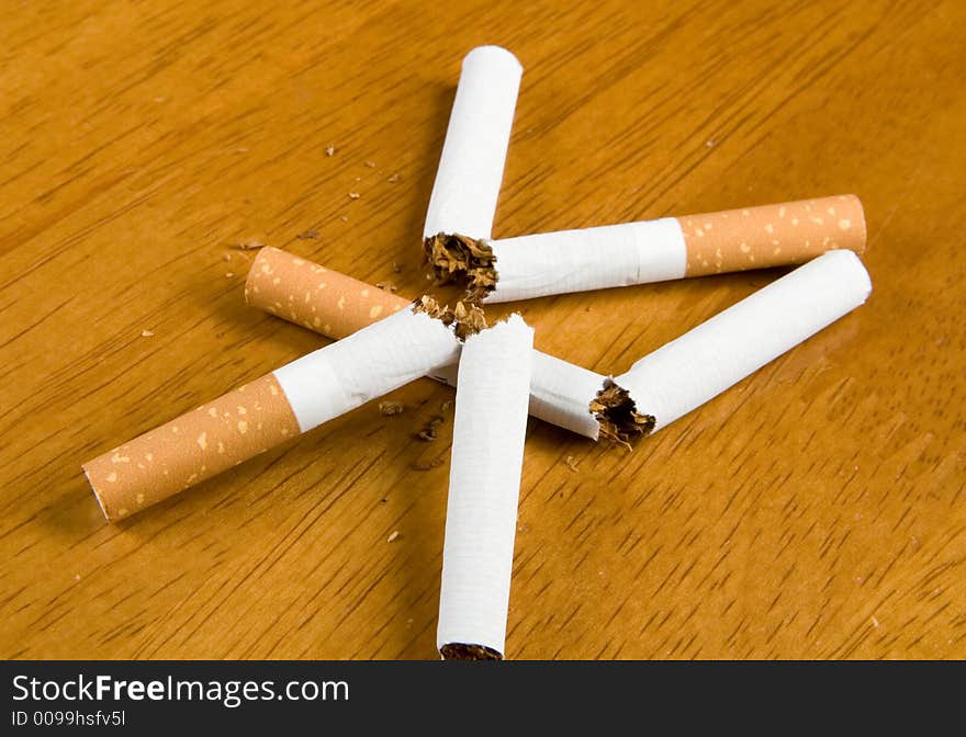 Broken cigarettes on a table. Broken cigarettes on a table