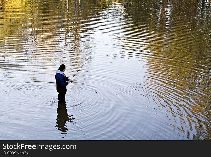 A Ohio man fishing in a creek in the fall - sunset is approaching. A Ohio man fishing in a creek in the fall - sunset is approaching.