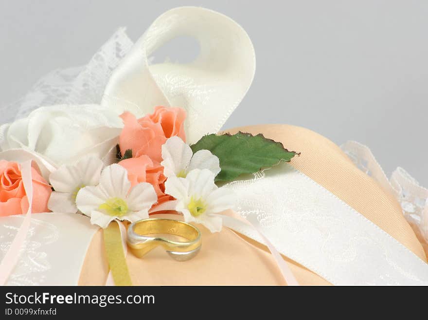 Wedding ring on a cushion with flowers and ribbons. Wedding ring on a cushion with flowers and ribbons