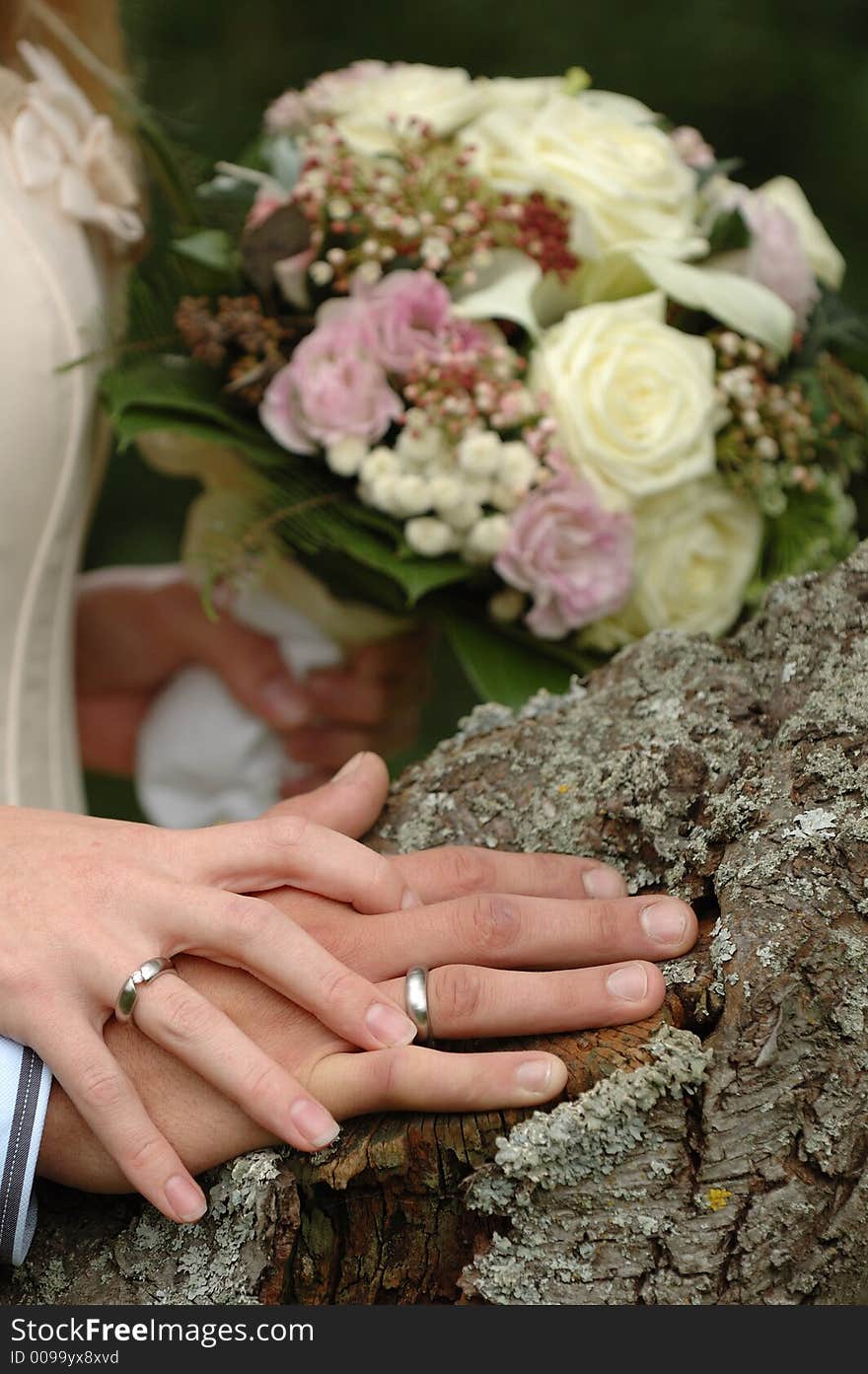 Hands, rings and bouquet