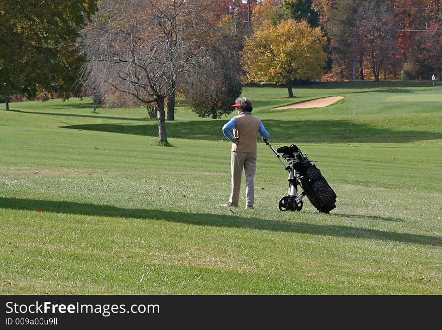 A lady golfer surveys the course