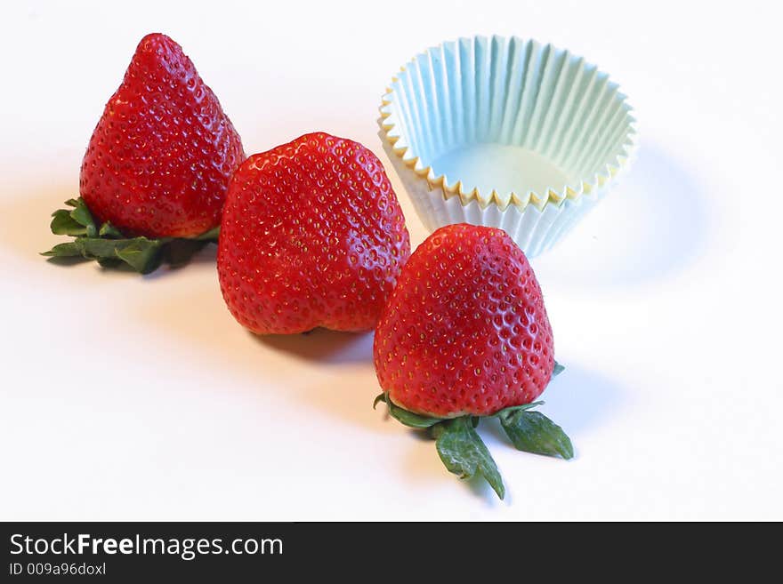 Three whole red ripe  strawberries. stack of pastel paper cupcake holders
An image shot on a white background with studio lights.
Heathy eating, treat, freshness,beginnings,
food & beverage
lifestyles. Three whole red ripe  strawberries. stack of pastel paper cupcake holders
An image shot on a white background with studio lights.
Heathy eating, treat, freshness,beginnings,
food & beverage
lifestyles