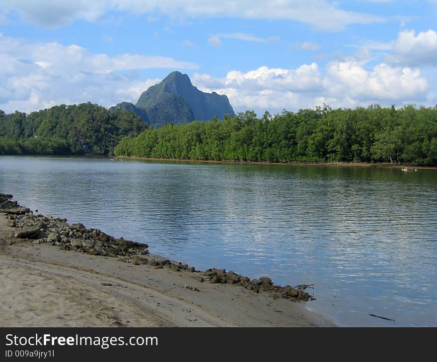 Approaching Thailand's Phang Nga Bay by the river's edge