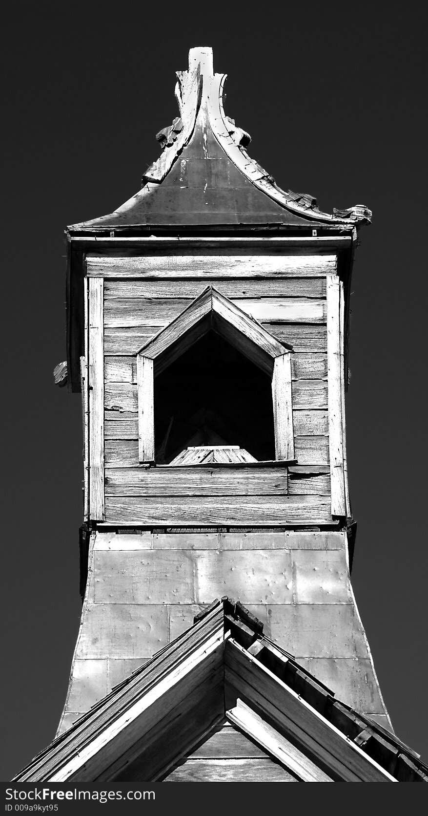 Old wooden church steeple against a dark sky in black and white. Old wooden church steeple against a dark sky in black and white