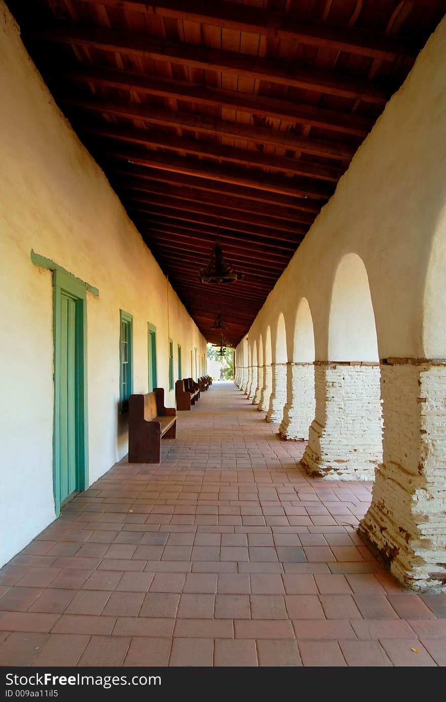 A series of arches along the main walkway of the San Juan Bautista Mission