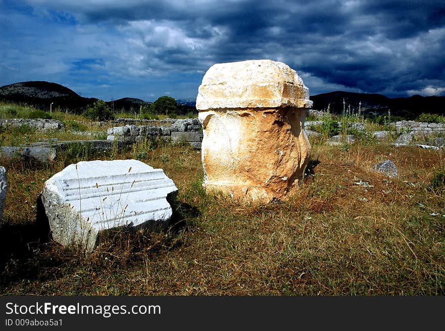 Remains of old roman abutment with before storm clouds.