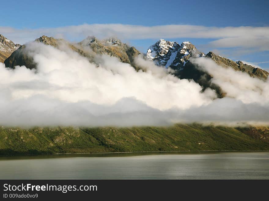 Cloudy mountain with snow on top and lake at New Zealand. Cloudy mountain with snow on top and lake at New Zealand