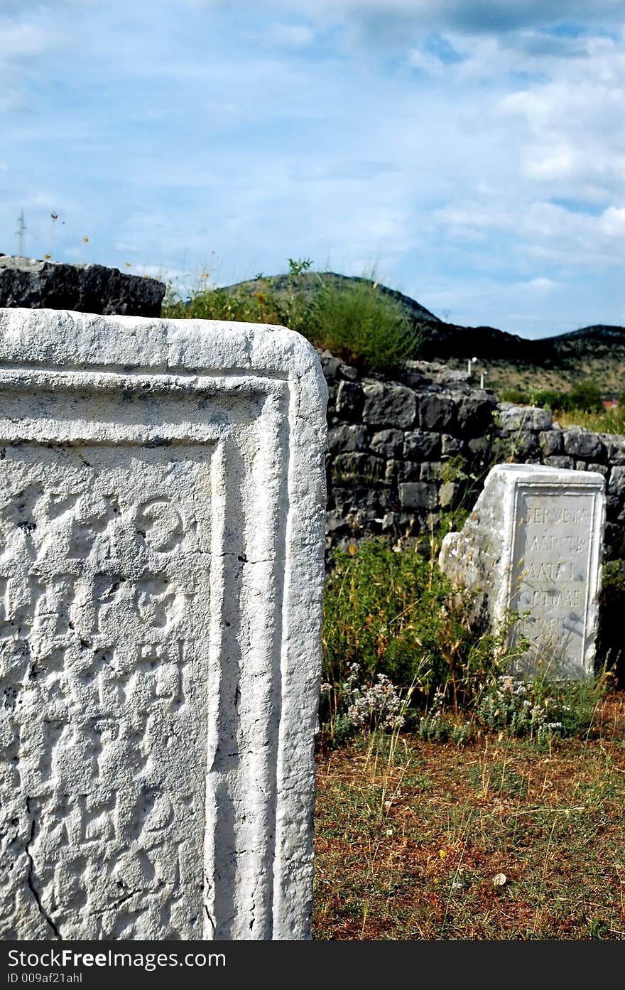 Remains of old roman abutment and epitaph with before storm clouds. Remains of old roman abutment and epitaph with before storm clouds.