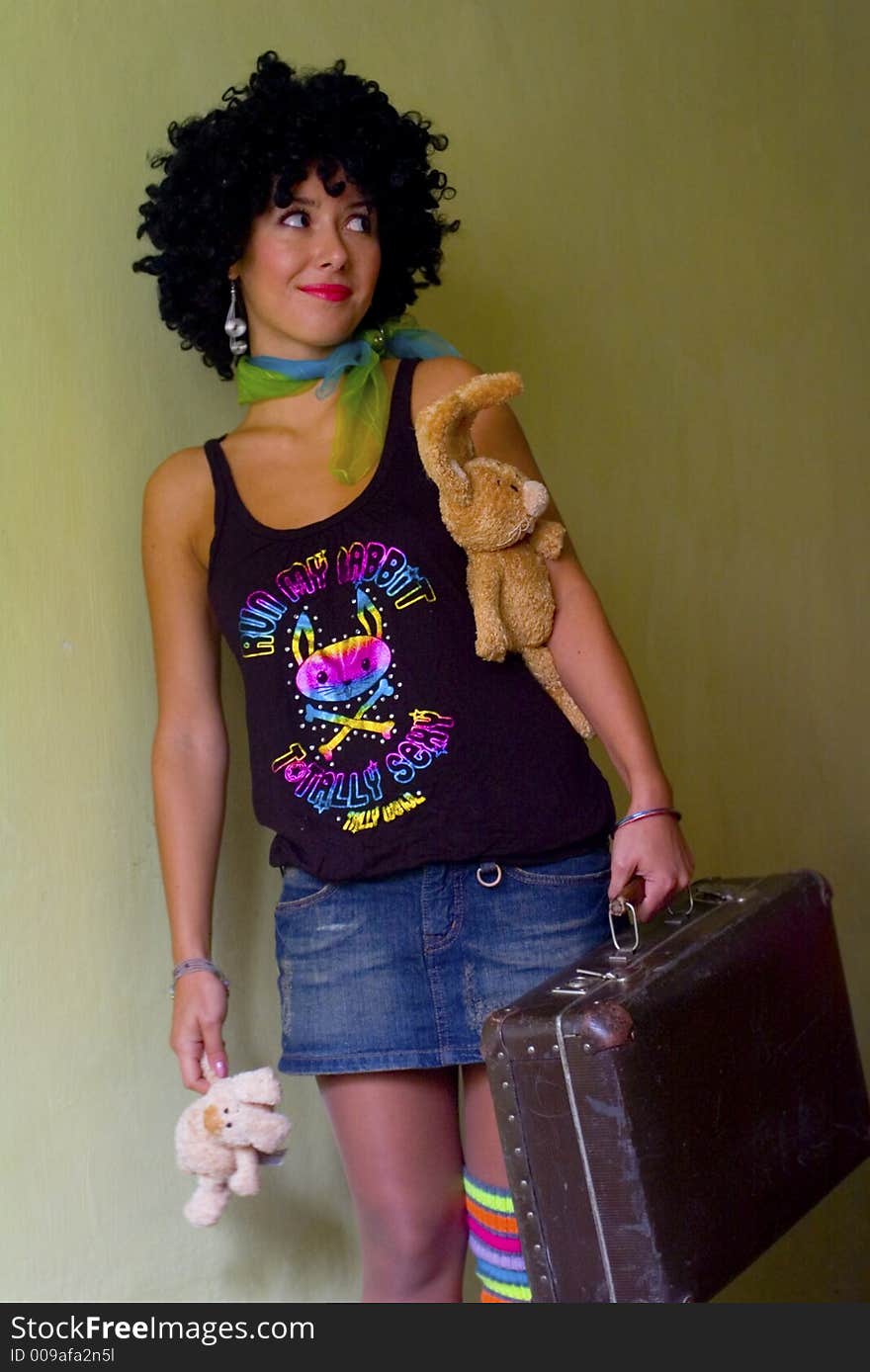 Cute curly disco girl with rabbits and suitecase going to travel