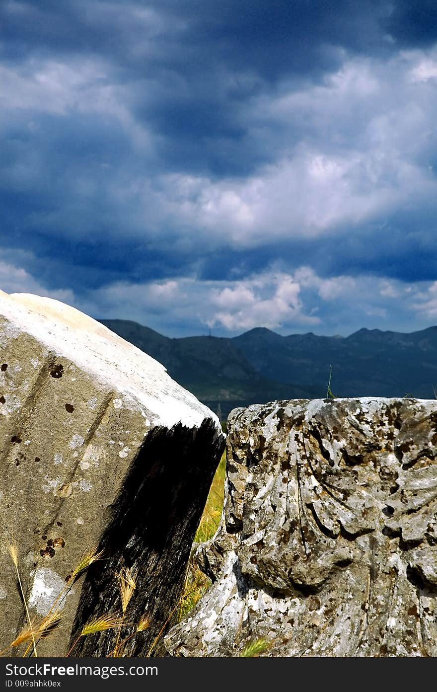 Remains of old roman abutment and epitaph with before storm clouds. Remains of old roman abutment and epitaph with before storm clouds.