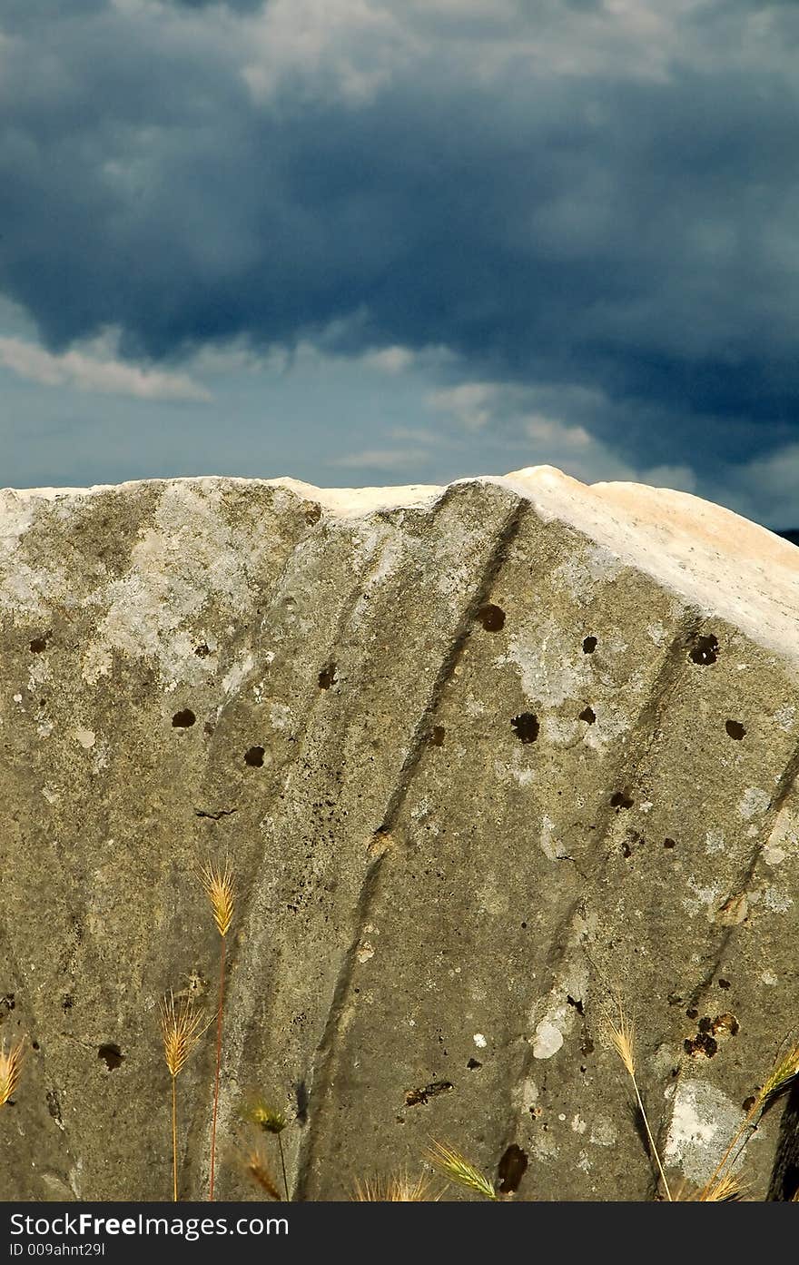 Remains of old roman abutment and epitaph with before storm clouds. Remains of old roman abutment and epitaph with before storm clouds.