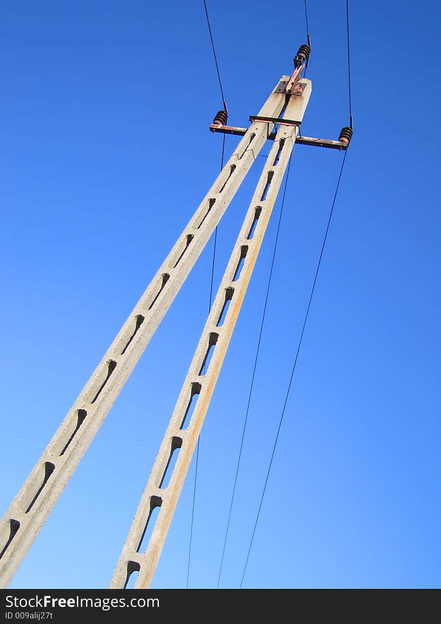 Utility tower and power lines against the blue sky