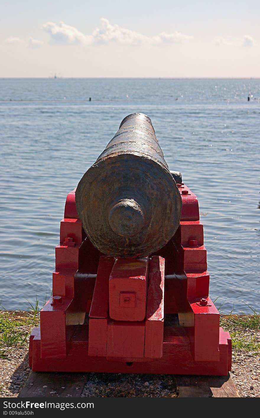 Looking across the barrel of a canon towards the sea