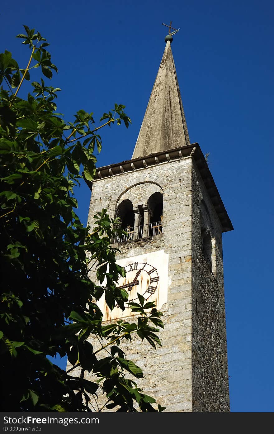 Bell tower of a small village in the alps. Italy.