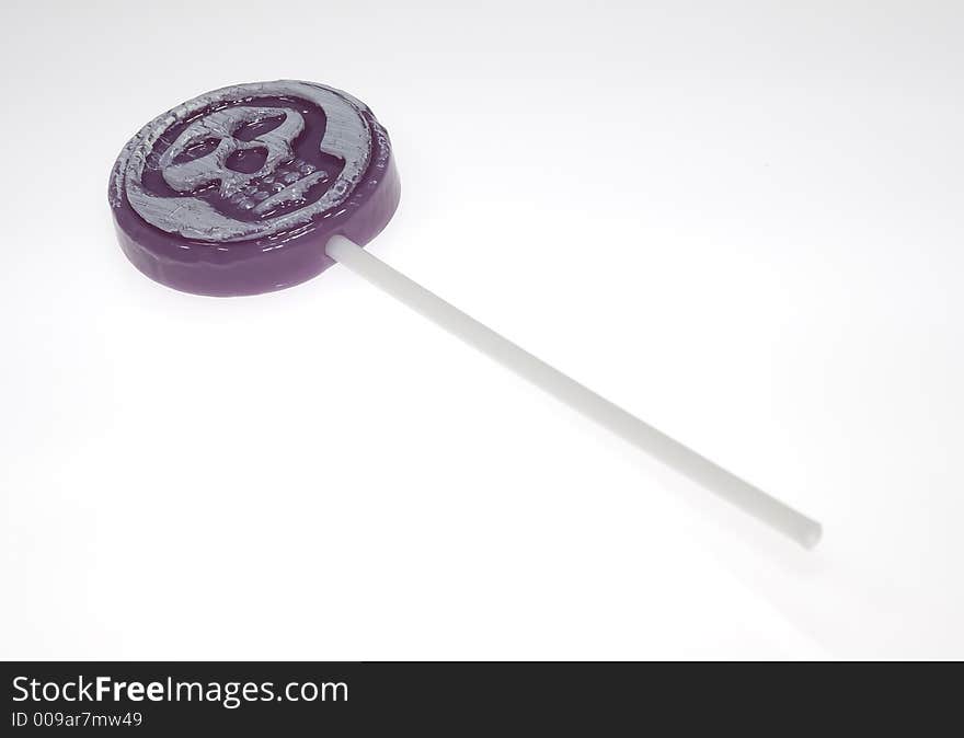 Photo of a Grape Lollipop With a Skull Image