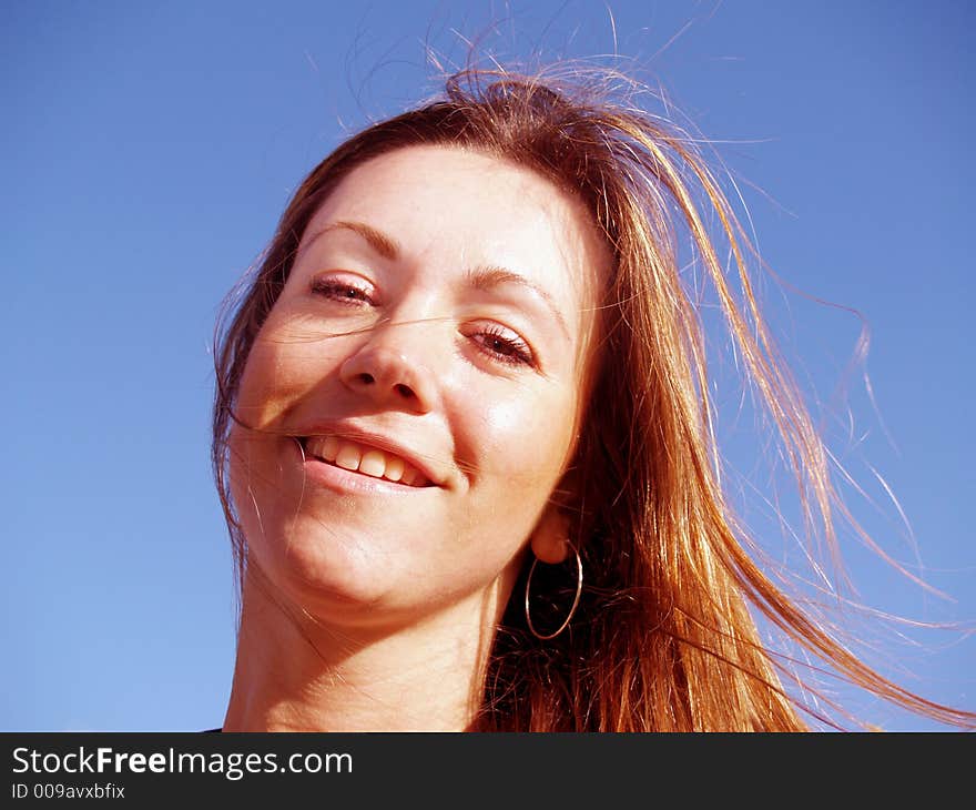 Fun with windswept hair amd blue sky