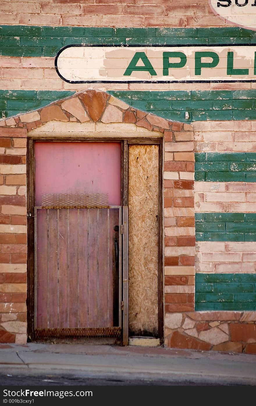 Wall and door to an abandoned appliance store. Wall and door to an abandoned appliance store