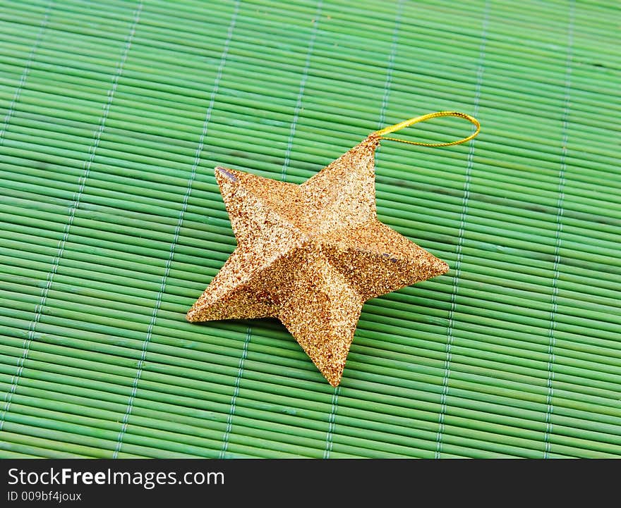 Star shaped Christmas decoration on a green background