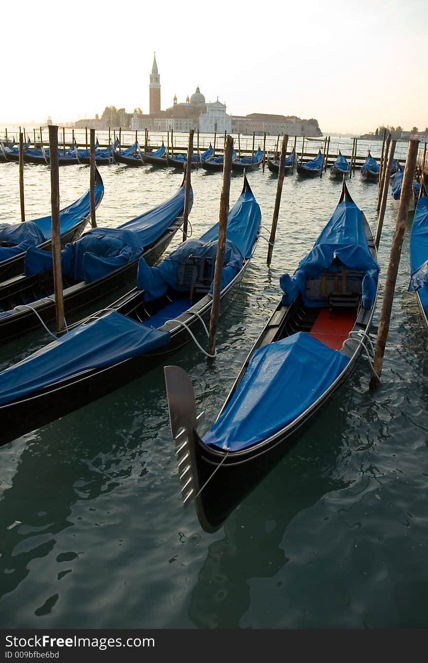 A row of  Gondolas in Venice. A row of  Gondolas in Venice.