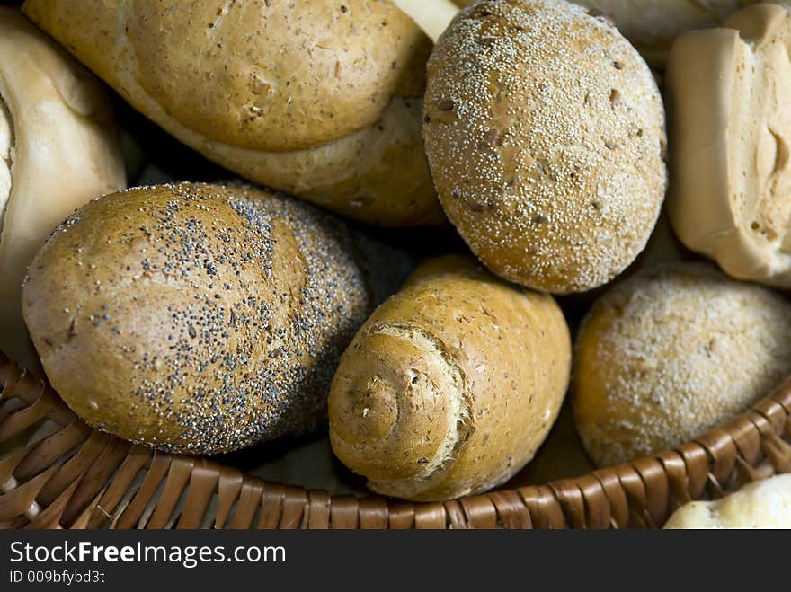 An assortment of breads in a basket. An assortment of breads in a basket