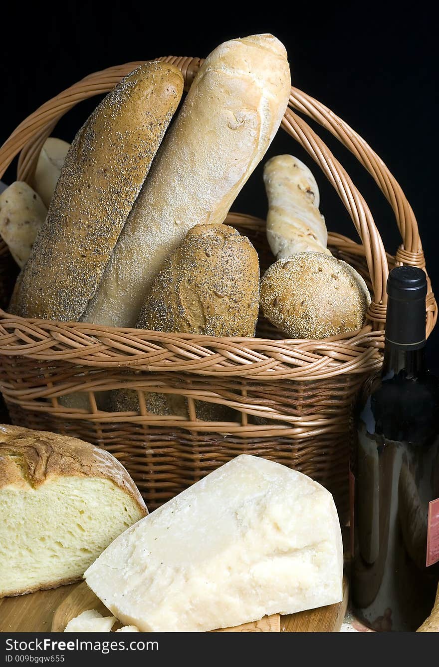 An assortment of hard cheeses and breads with wine. An assortment of hard cheeses and breads with wine