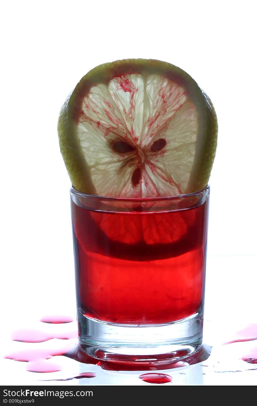 Glass with red wine and lemon slice