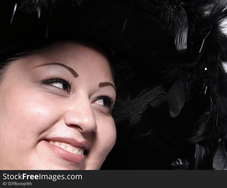 Beautiful Hispanic Woman in a feathered Hat. Beautiful Hispanic Woman in a feathered Hat