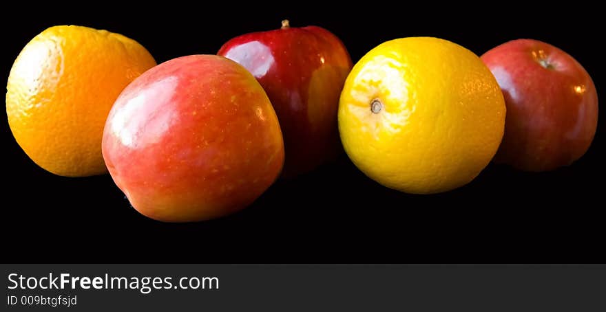 Apples and Oranges on a black background.