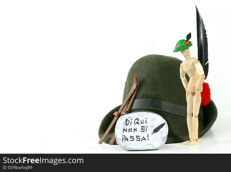 Alpini Hat (the sacred symbol of Italy's elite mountain troops) and skis on a rock. Alpini Hat (the sacred symbol of Italy's elite mountain troops) and skis on a rock.