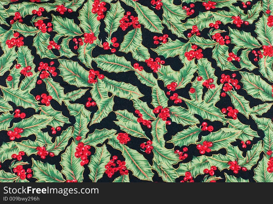 Christmas fabric with a holly leaf and berry pattern. Christmas fabric with a holly leaf and berry pattern