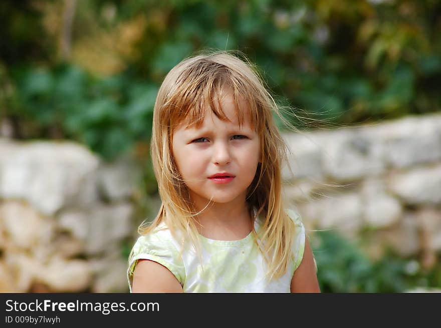 Cute blonde girl in a wild life