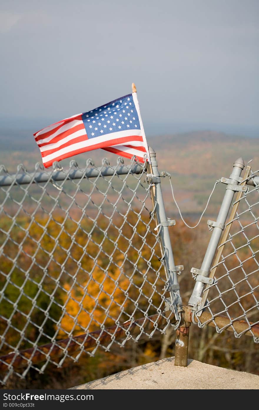 American Flag on Mountain Top and Foliage