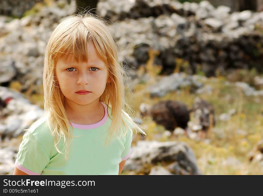 Portrait of cute blonde girl in a wild life