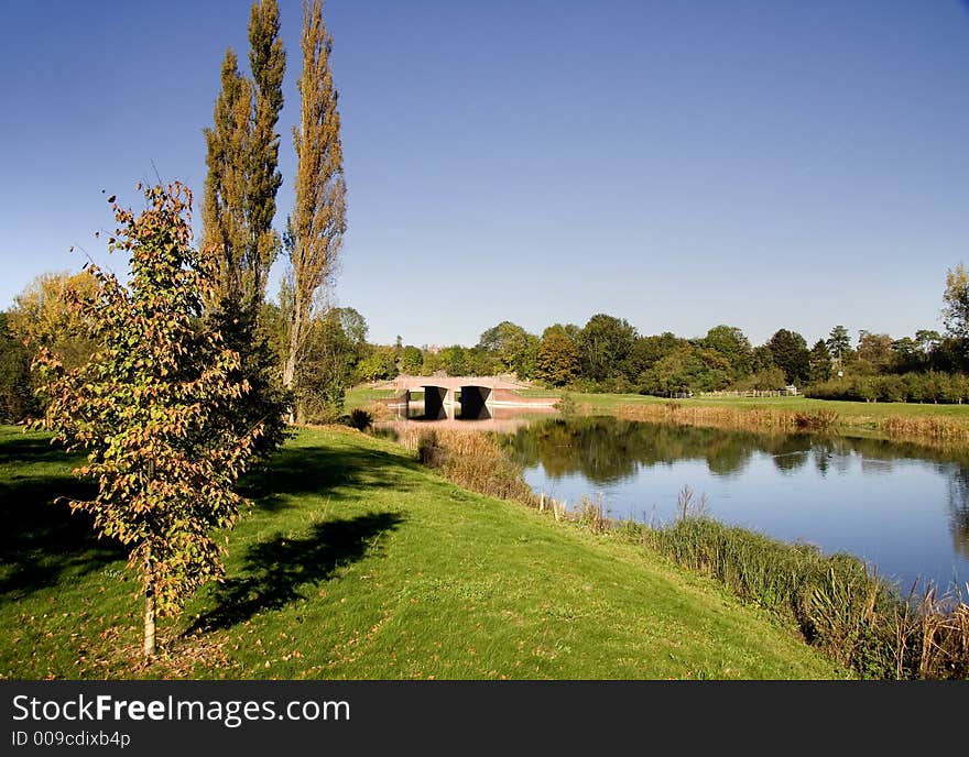 Autumnal scene of a Bridge over a tranquil river in England. Autumnal scene of a Bridge over a tranquil river in England