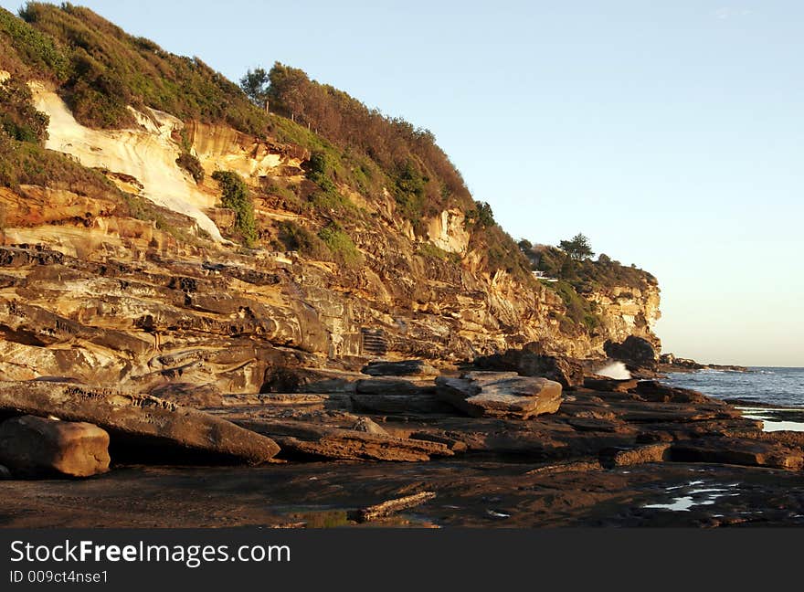 Steep Cliffs At The Sydney Coast In Golden Morning Light, Australia