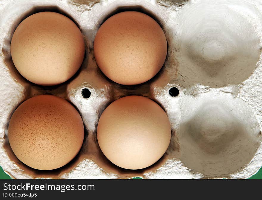 Four Brown Eggs In A Grey Cardboard Box. Four Brown Eggs In A Grey Cardboard Box