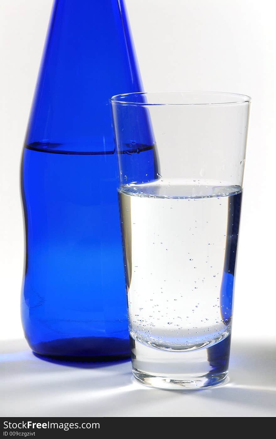 Glass of Mineral Water and Blue Bottle. Glass of Mineral Water and Blue Bottle