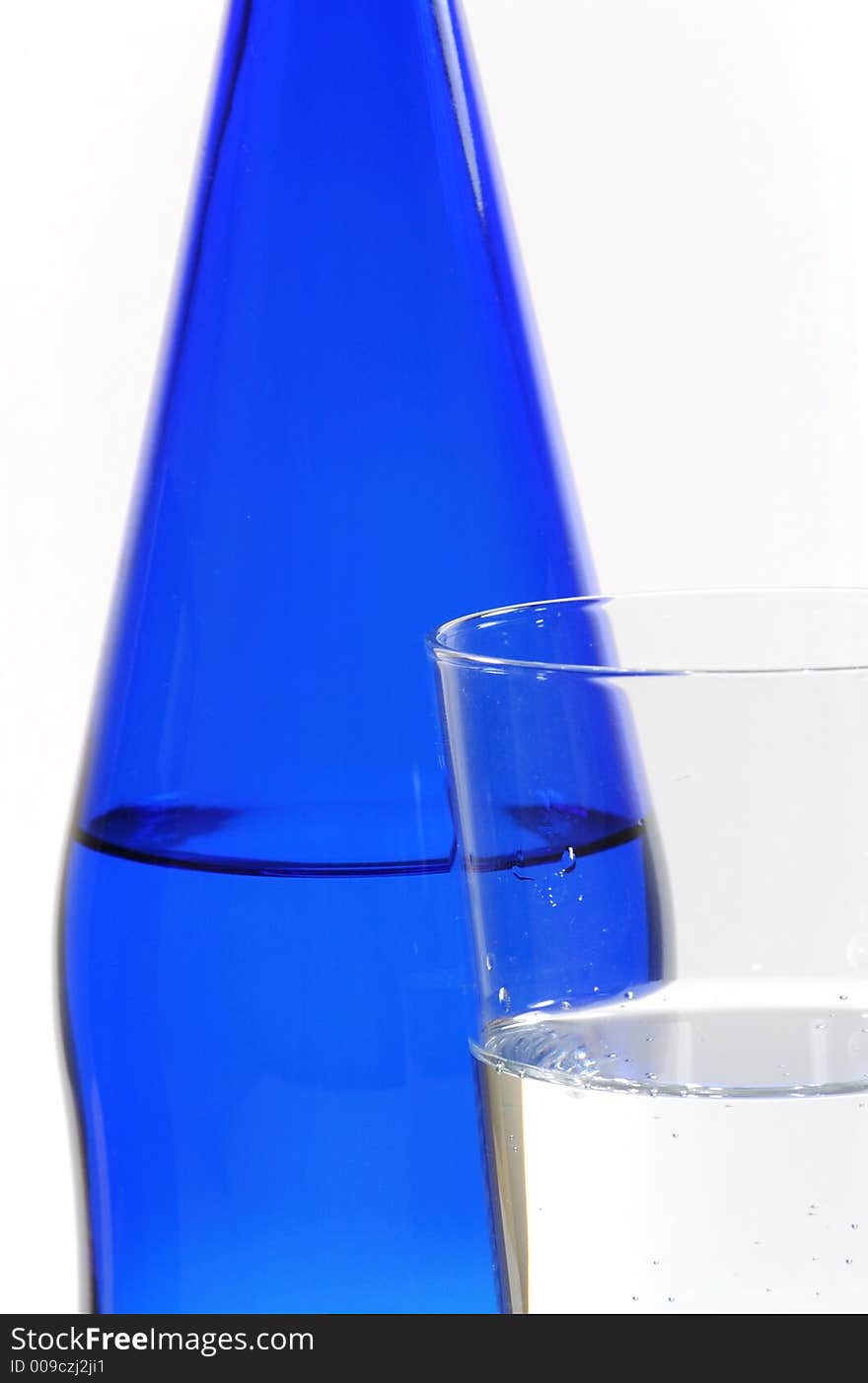 Glass of Mineral Water and Blue Bottle. Glass of Mineral Water and Blue Bottle