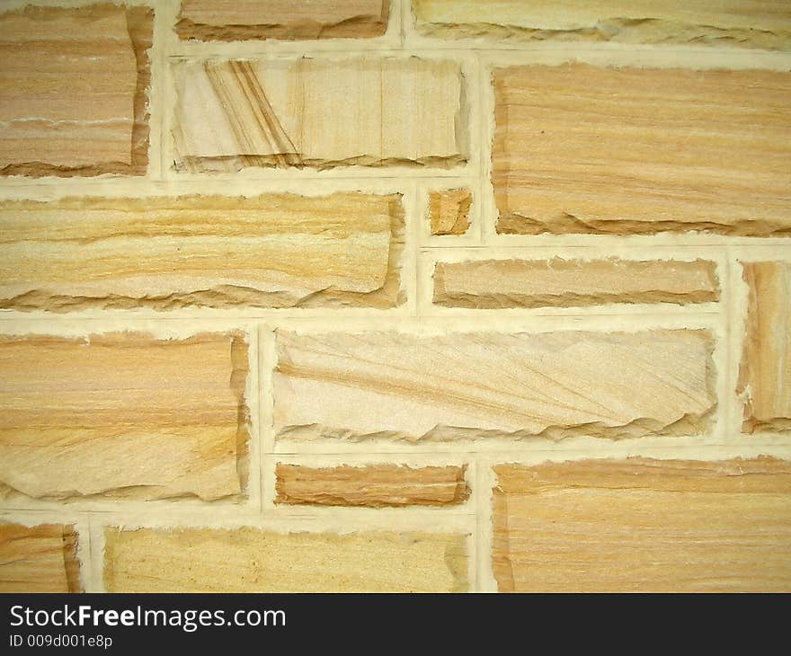 Wall background made from sandy colored stones. Wall background made from sandy colored stones