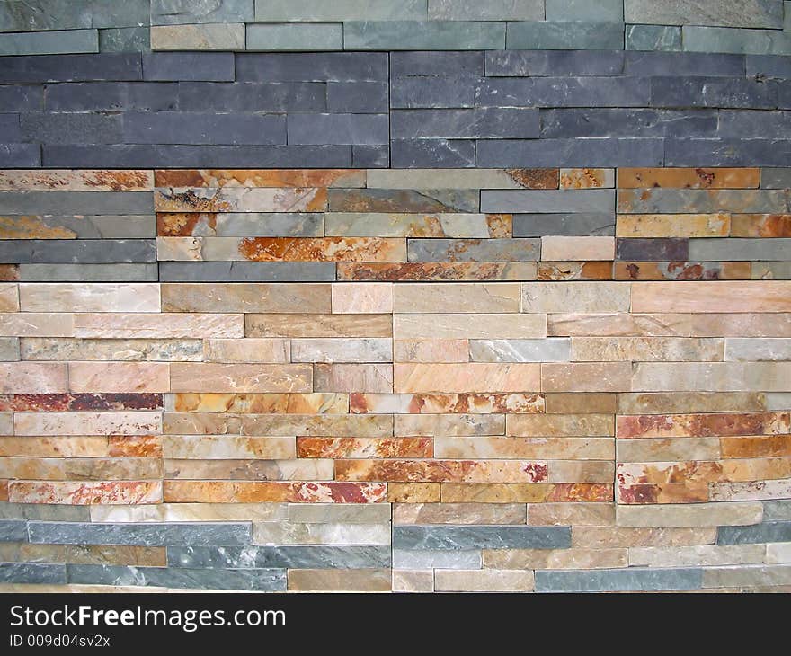 Wall background made from small colorful stone bricks. Wall background made from small colorful stone bricks