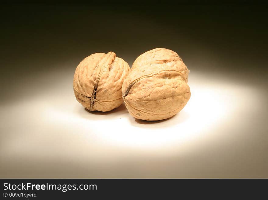 Walnuts on white board in the dark