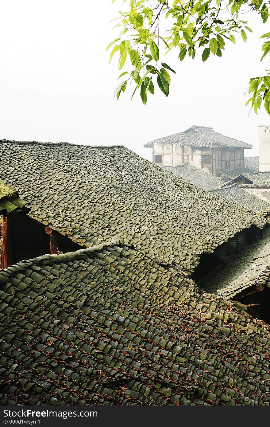 Old folk house with tile roof in morning sunlight