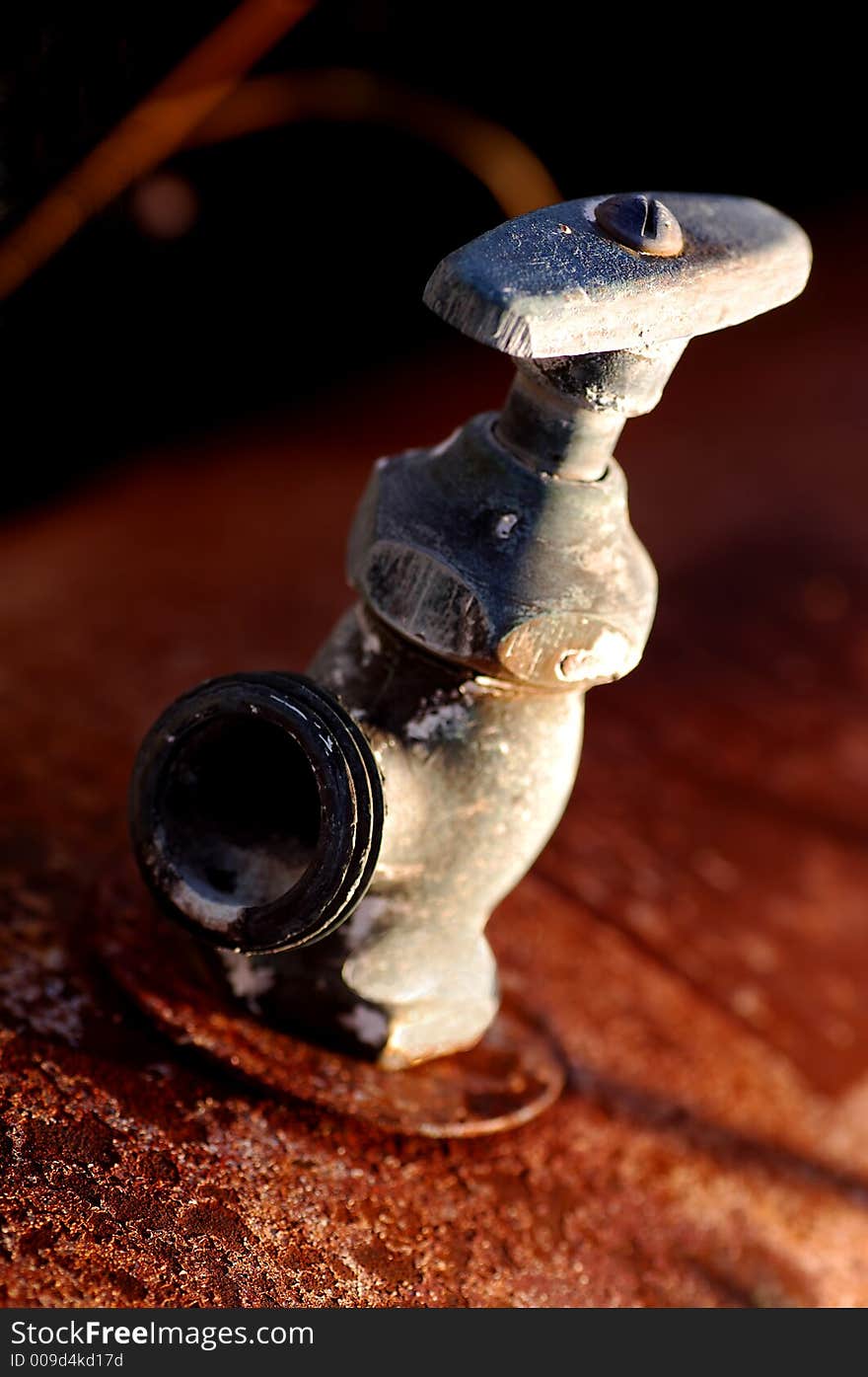 Rusted old hose bib rotting in the desert