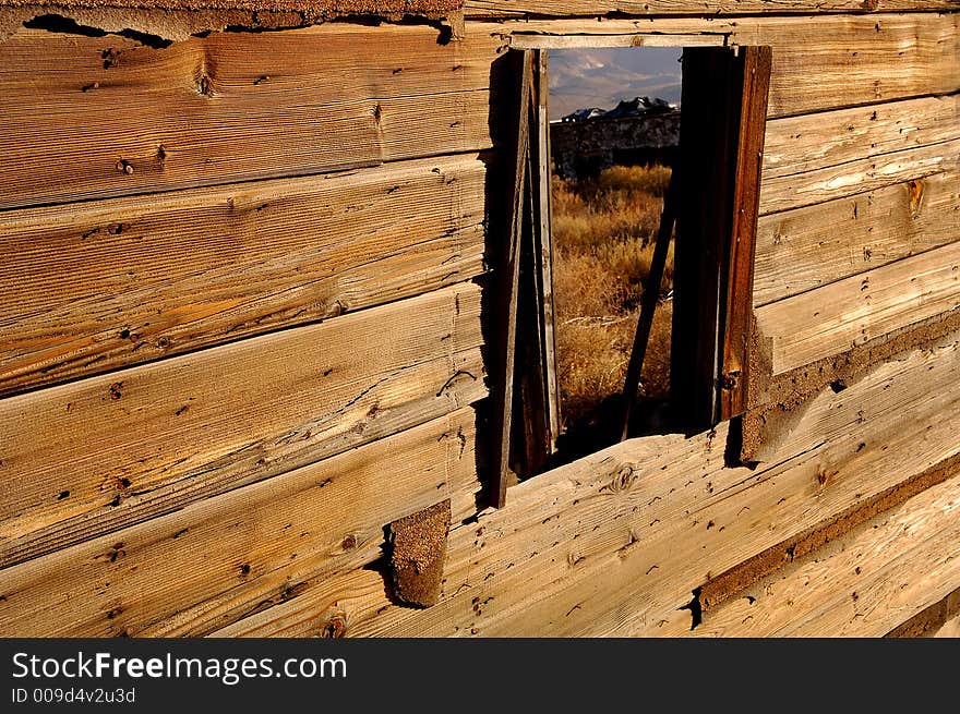 View of the mountains through a old building window. View of the mountains through a old building window